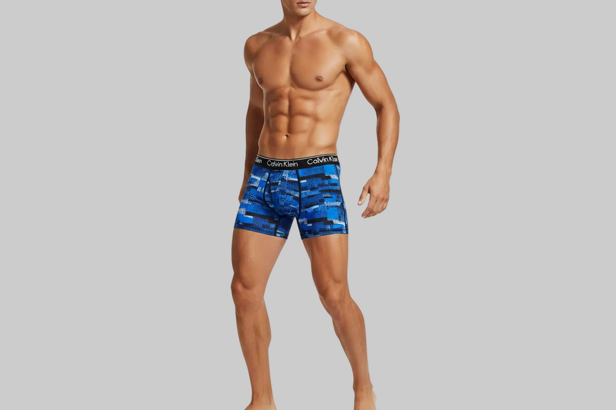 Calvin Klein Boys Performance Boxer Brief Underwear 4-Pack Blue/Mix Prints Medium wearing the men